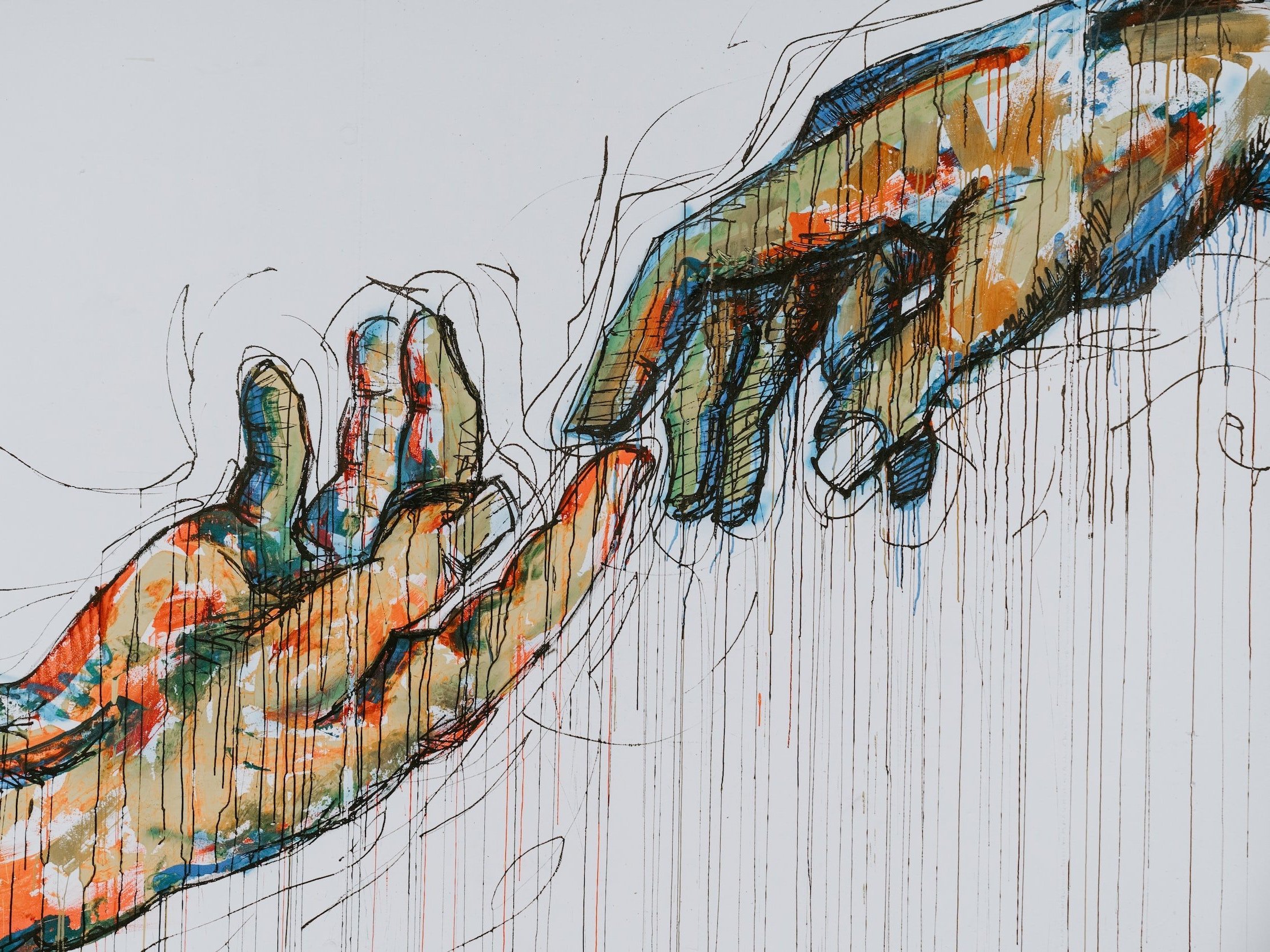 Two drawn and painted hands extend toward one another.