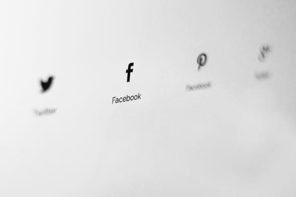 Blurred social media logos for Twitter, Facebook, Pinterest, and Tumblr on a white background, focusing on connectivity.