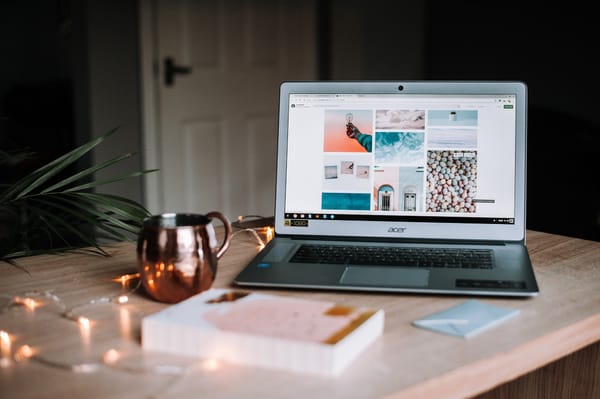 Laptop displaying an online portfolio with a cozy work setup, highlighting the professional benefits.