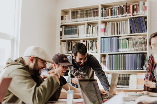 Creative professionals collaborating in office, showcasing value of teamwork and soft skills for freelancers/designers.