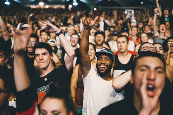 Excited crowd at live event, demonstrating engaging alternatives to social media for connecting with target audiences.
